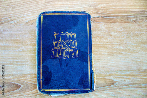Wallpaper Mural Old dusty Hebrew Bible book Tanakh (Tanach) on a background of wood (translated from Hebrew on the book Hebrew Bible Tanakh: Torah, Neviim, Ketuvim), Israel Torontodigital.ca