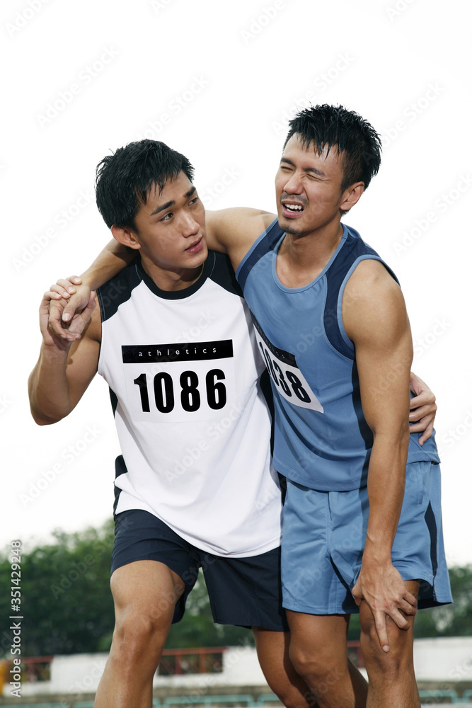 Man helping injured man Man helping injured man