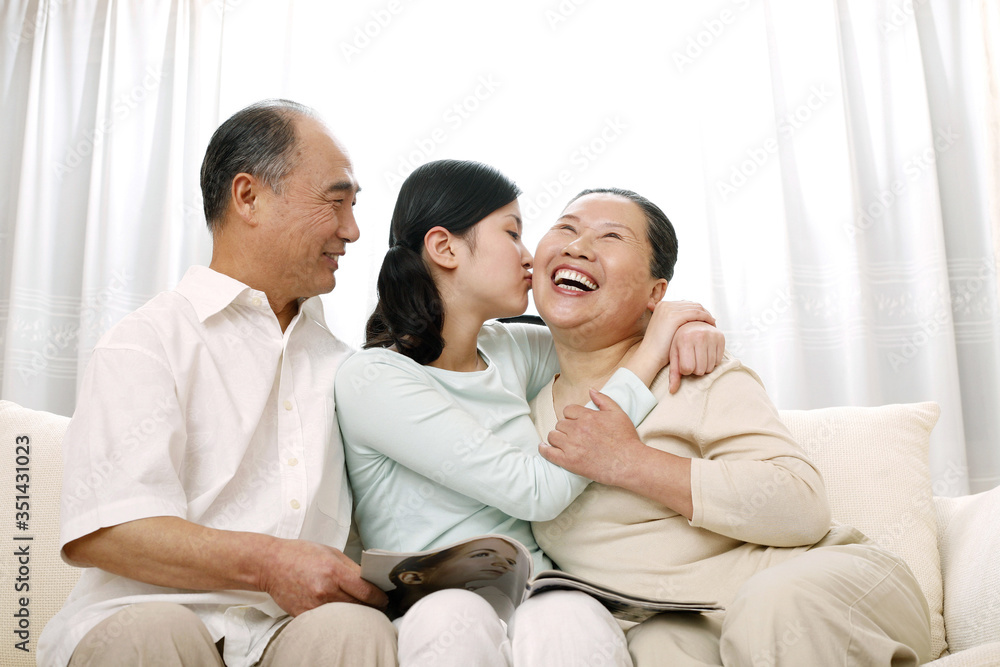 Fototapeta premium Woman giving senior woman a peck on the cheek