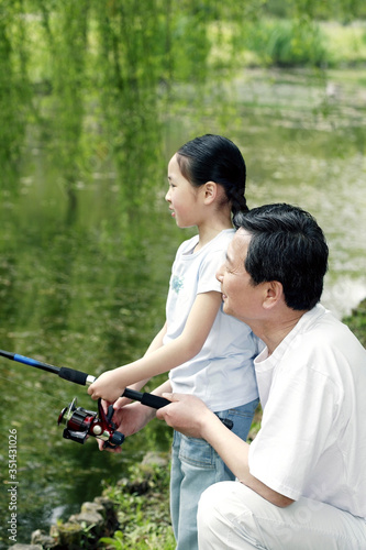Senior man and girl fishing