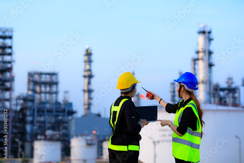 Smart two female engineer discussion together at refinery industry plant at industry factory center area. Engineering Concept