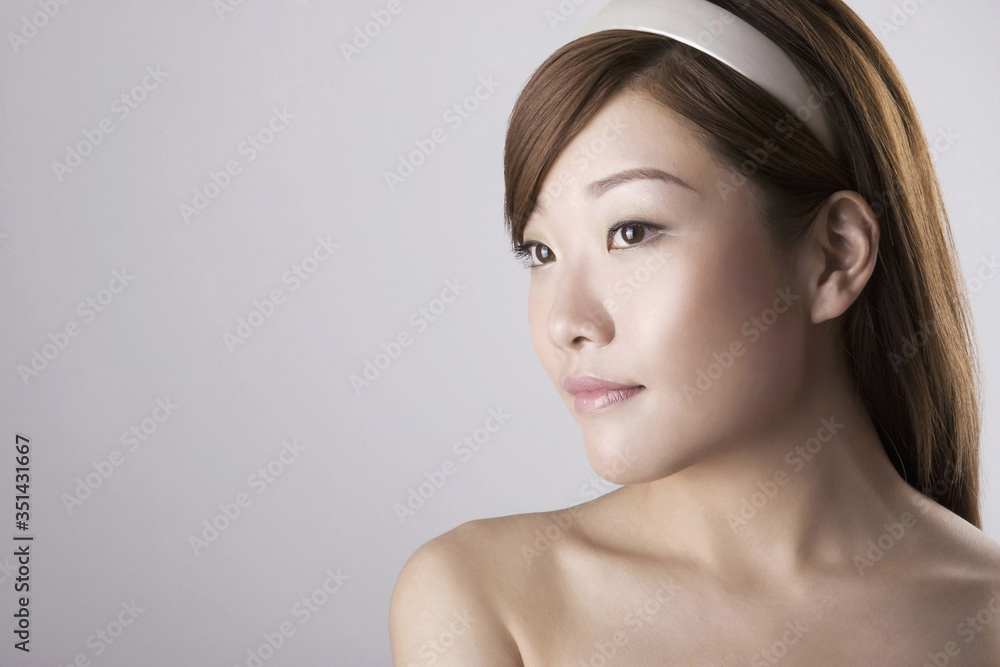Woman with head band looking to the side Woman with head band looking to the side