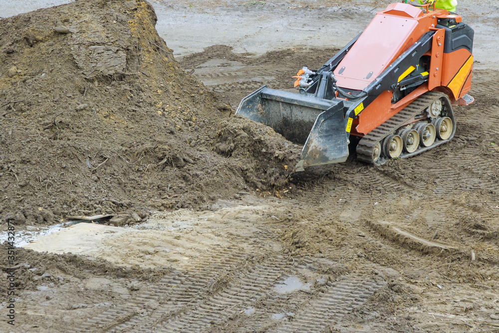 Earth-moving equipment, yellow bulldozer digging ground during pushes a soil Earth-moving equipment, yellow bulldozer digging ground during pushes a soil