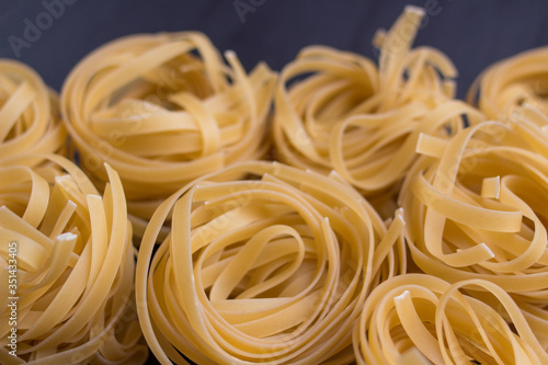 tagliatelle noodles on black background