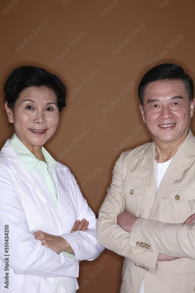 Senior man and senior woman posing with their arms folded Senior man and senior woman posing with their arms folded