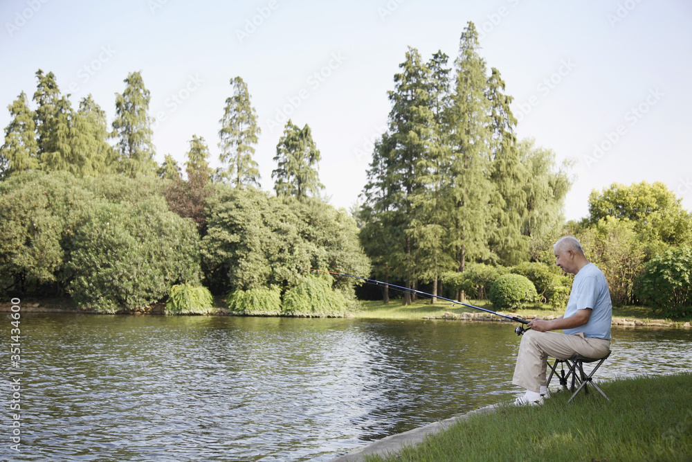 Senior man fishing at the lake Senior man fishing at the lake