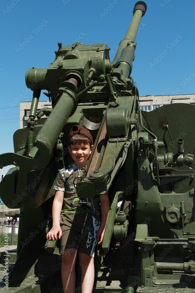 Fototapeta premium boy and military equipment