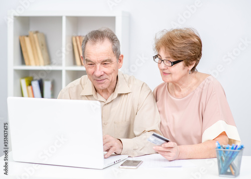 Senior couple use laptop and do online shopping