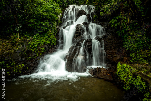 Waterfall landscape. Beautiful hidden Jembong waterfall in tropical rainforest in Ambengan  Bali. Slow shutter speed  motion photography.