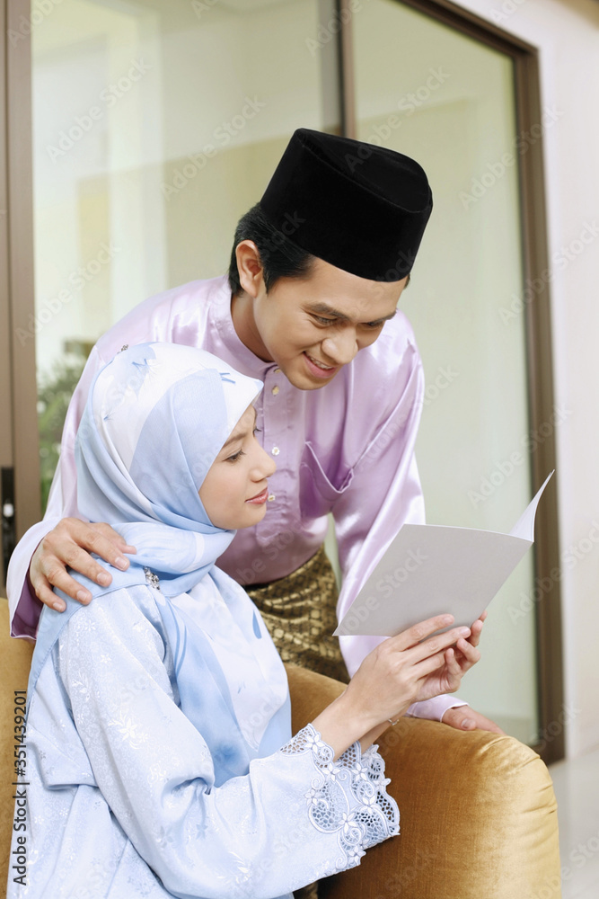 Man and woman reading greeting card Man and woman reading greeting card