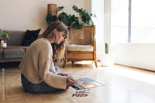 Photography Woman assembling a jigsaw puzzle of Nyhavn, Copenhagen during coronavirus quarantine