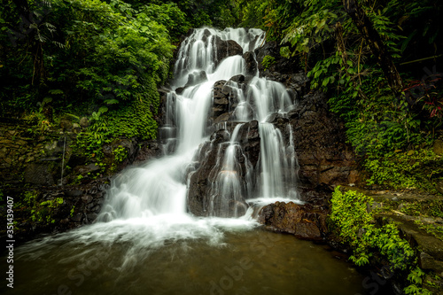 Waterfall landscape. Beautiful hidden Jembong waterfall in tropical rainforest in Ambengan  Bali. Slow shutter speed  motion photography.