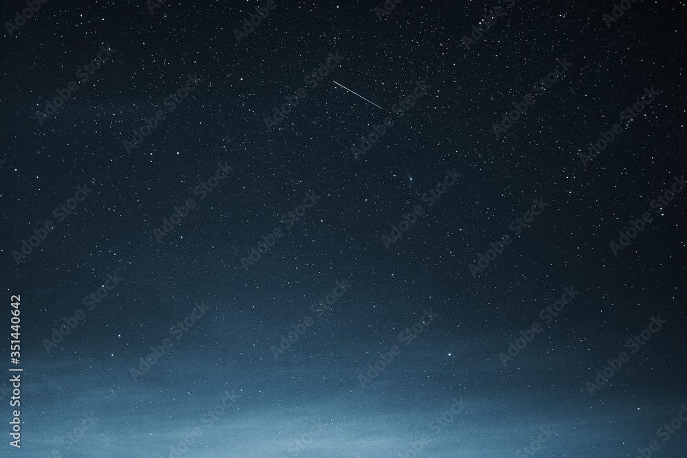 Fototapeta premium Shooting star in the dark blue sky over Greenland