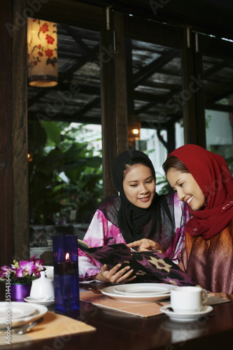 Women reading menu at restaurant