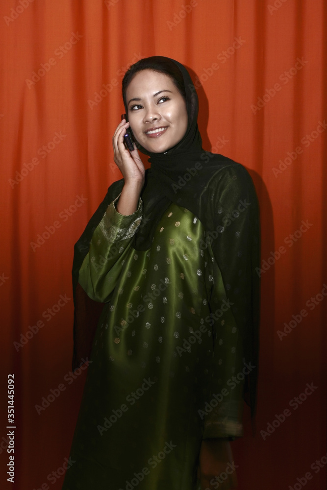 Woman in traditional clothing talking on the phone Woman in traditional clothing talking on the phone