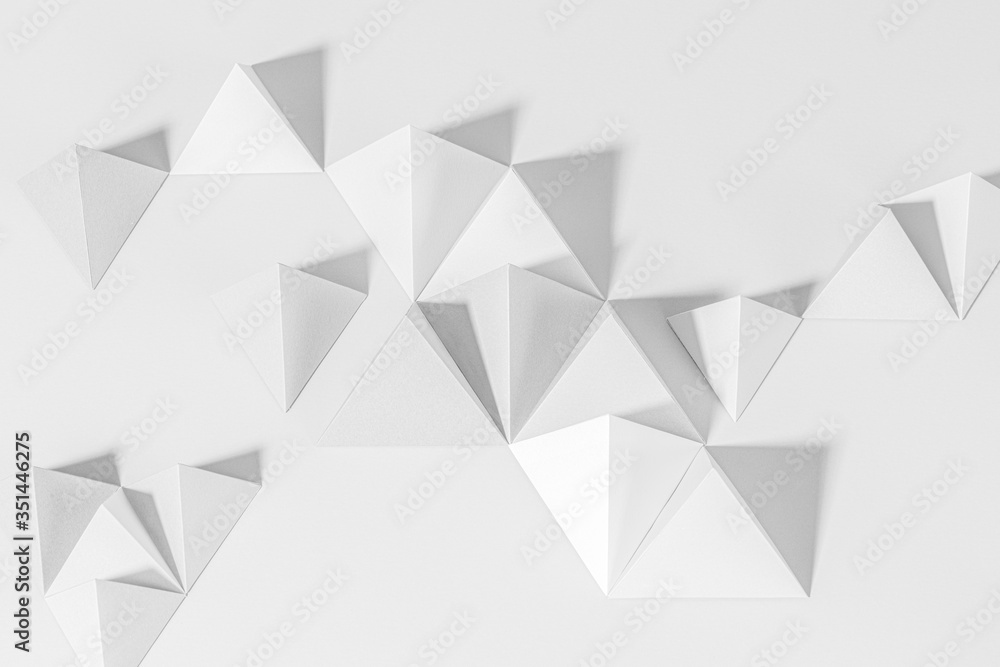 3D gray pyramid paper craft on a gray background 3D gray pyramid paper craft on a gray background
