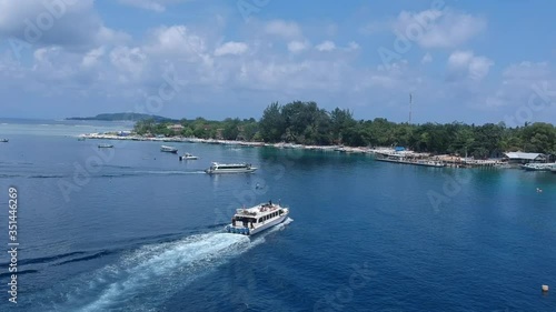 passenger boats sail to the pier in asia gili air