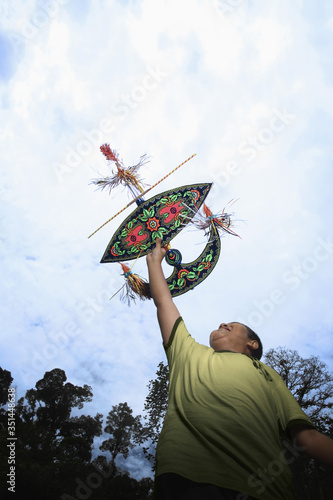 Boy flying moon-kite