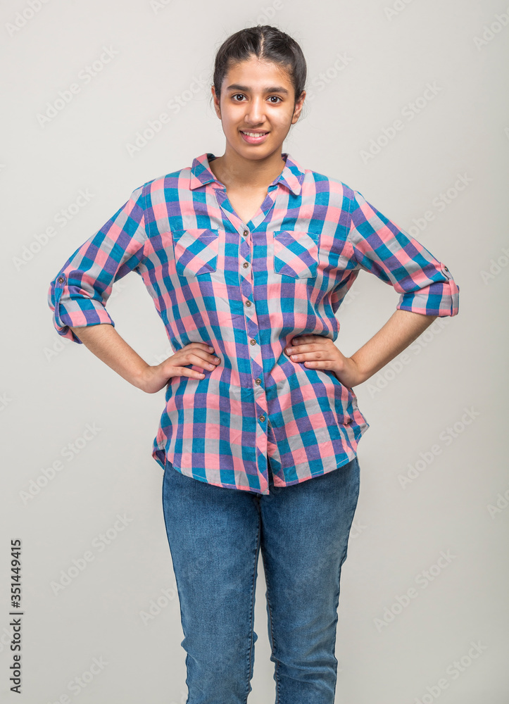 Indoor image of beautiful happy Indian girl looking at camera