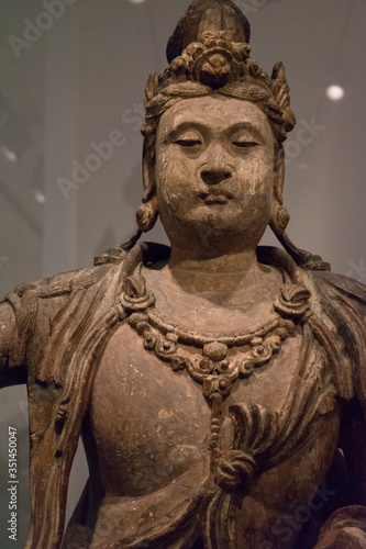 Ancient Chinese Buddha sculpture in the museum. Beautiful Buddha statue.