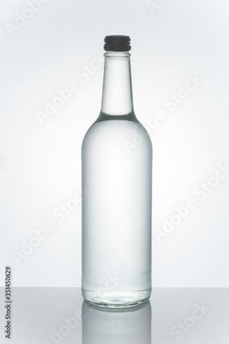 Mineral water in a clear glass bottle mockup