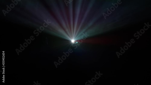 Bright color beam of video projector against dark background