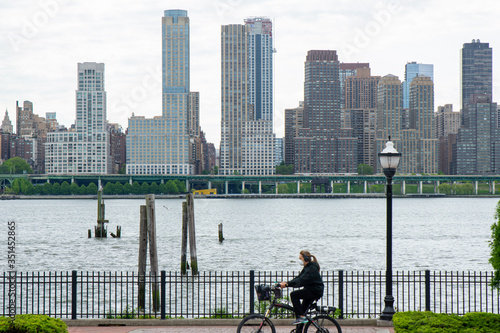 A New Jersey cyclist rides past the New York City Skyline while in quarantine
