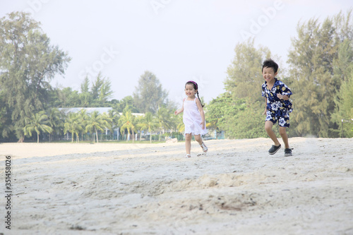 Boy and girl having fun on the beach