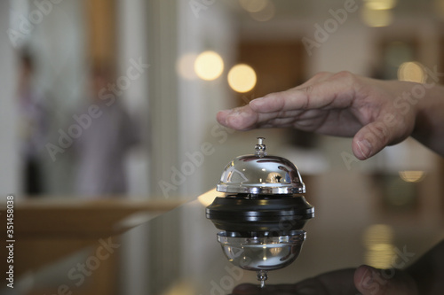 Hand about to ring service bell