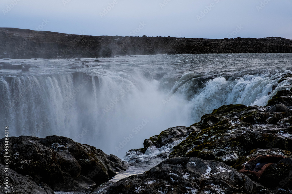 Selfoss waterfall in Northeast Iceland runs through a rock gorge through the autumn snow Selfoss waterfall in Northeast Iceland runs through a rock gorge through the autumn snow