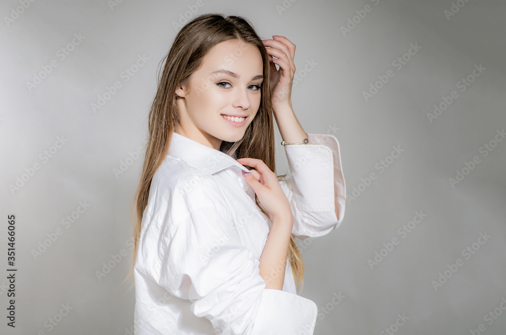 Young beautiful cute cheerful girl smiling looking at camera over grey background. Attractive beauty girl smiling looking at camera.
