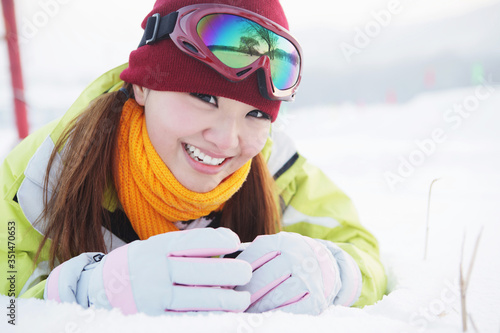 Woman lying forward in snow