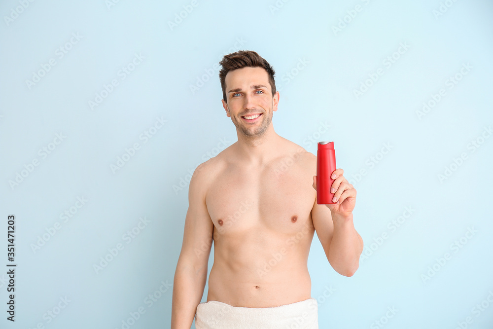 Handsome man with shower gel on color background Handsome man with shower gel on color background