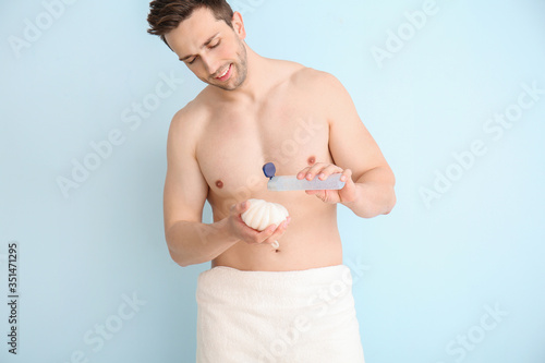 Handsome man with shower ge...