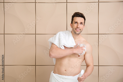 Handsome man taking shower ...