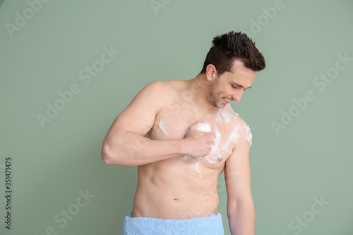 Handsome man taking shower ...