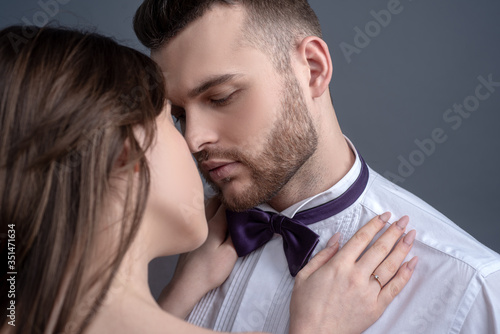 Elegand couple kissing. Touching body ecstasy and pleasure. Making love to young lover. Face sensual concept. Sensual kiss for young lovers. Affectionate couple caressing adoring each other. photo