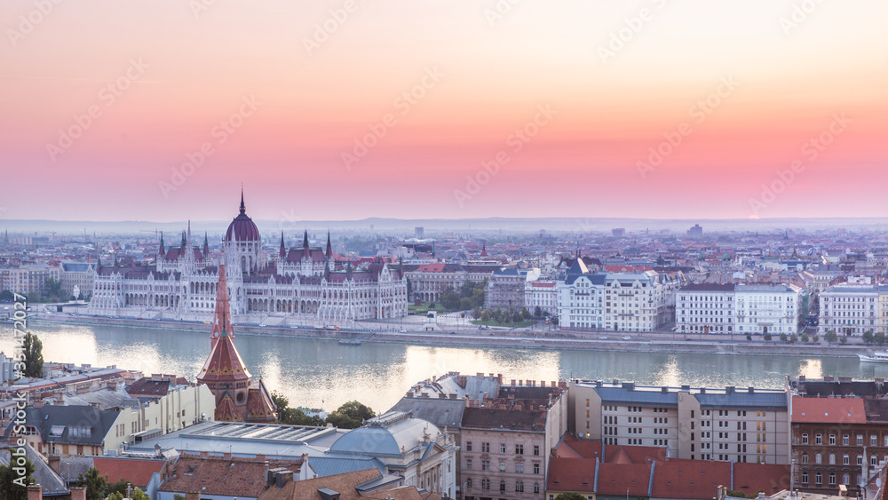 Panoramic cityscape of Hungarian parliament building on the Danube river. Colorful sunrise in Budapest, Hungary