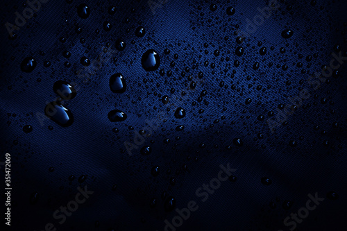 Water drops on the dark fabric.water drops on black background