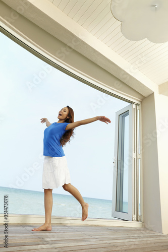 Woman skipping with her arms outstretched