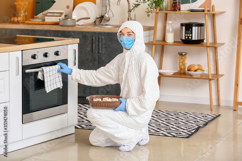 Woman in biohazard suit coo...