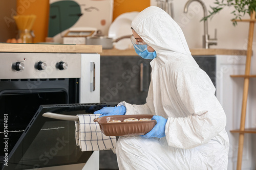 Woman in biohazard suit coo...