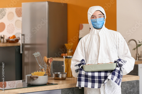Woman in biohazard suit coo...