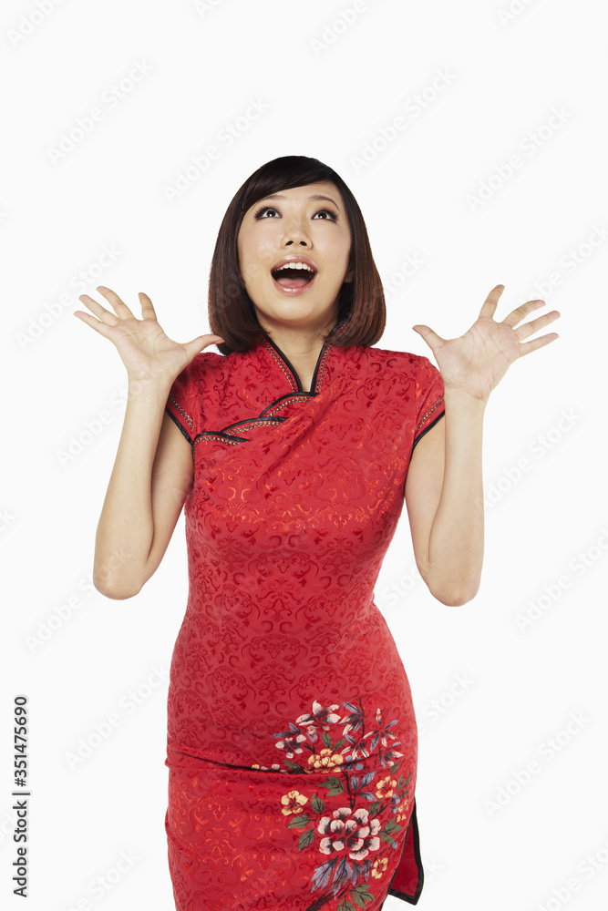 Woman in traditional clothing with looking surprised with hands opened