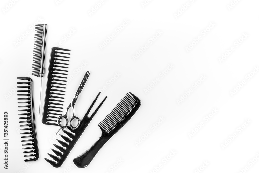 Combs, hairbrush, scissors on white desk from above copy space