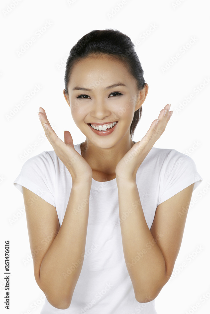 Happy woman smiling with hands opened under her chin Happy woman smiling with hands opened under her chin