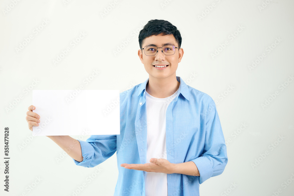 Young asian man holding poster Young asian man holding poster