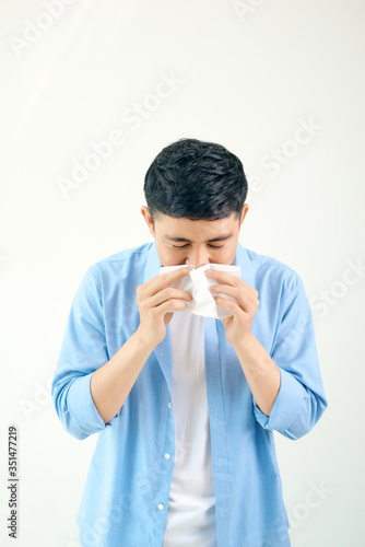 Sick young man handsome and sneeze isolated on white wall background. Concept of sick. Asia people.