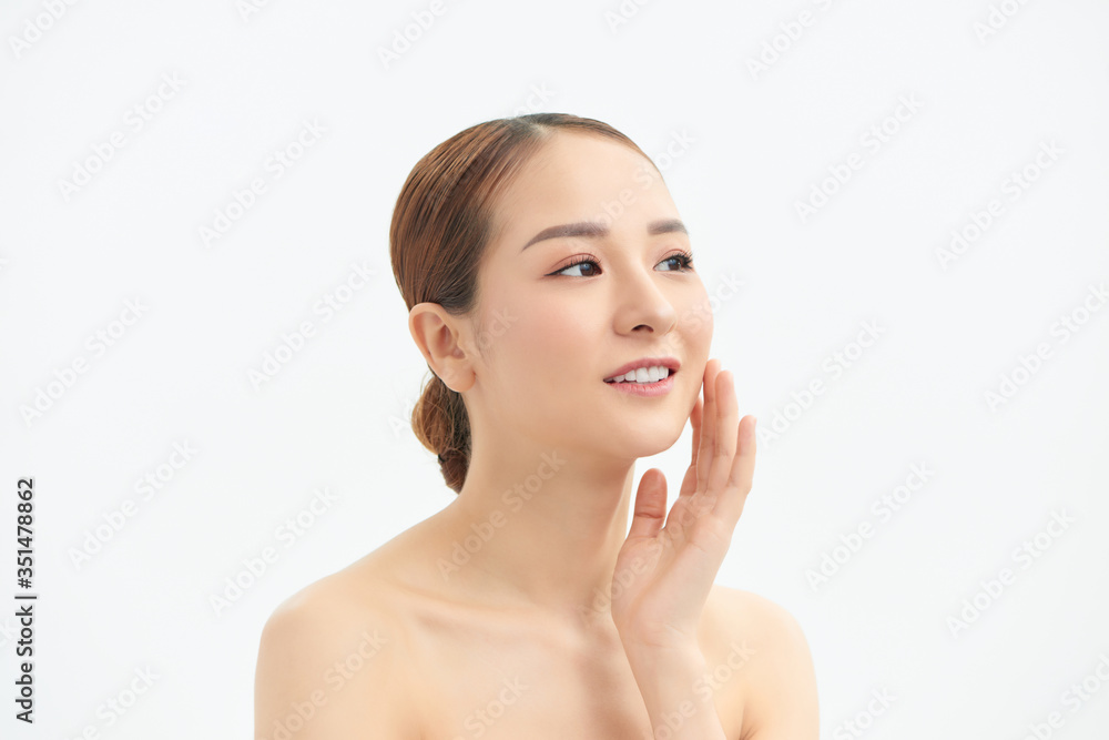 Young woman touching her face isolated on white background Young woman touching her face isolated on white background
