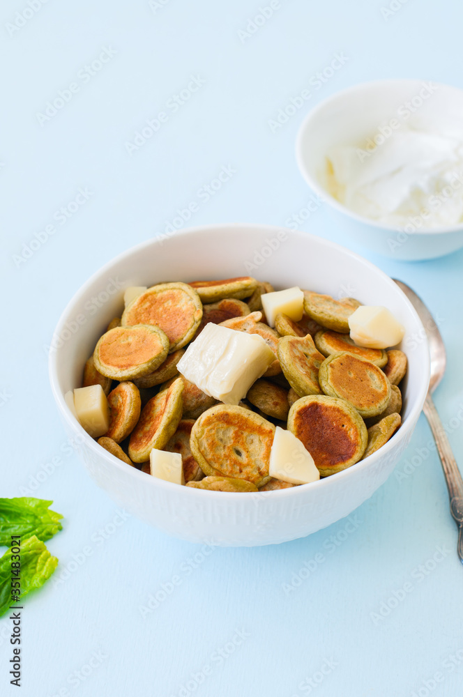 Spinach pancake cereals in a white bowl. Spinach pancake cereals in a white bowl.